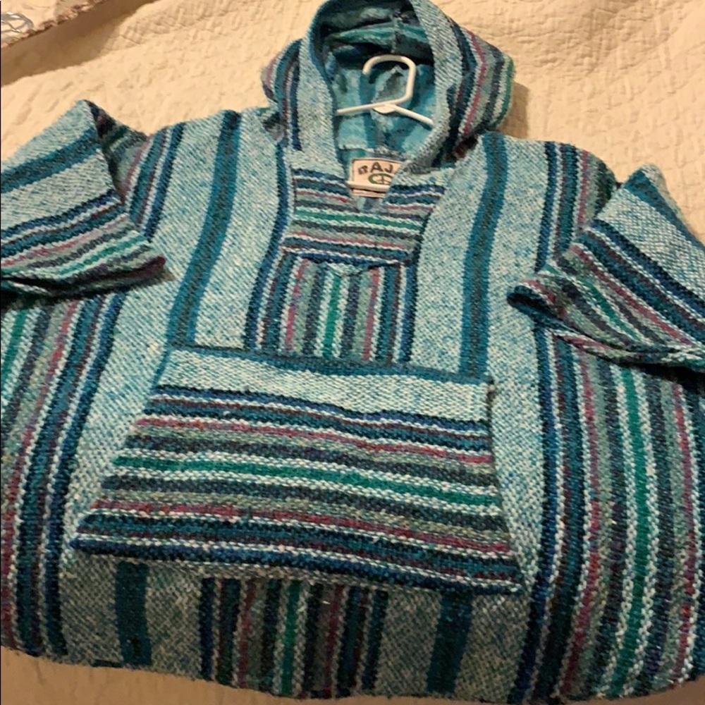 Poncho with hoodie and a pocket in the front
